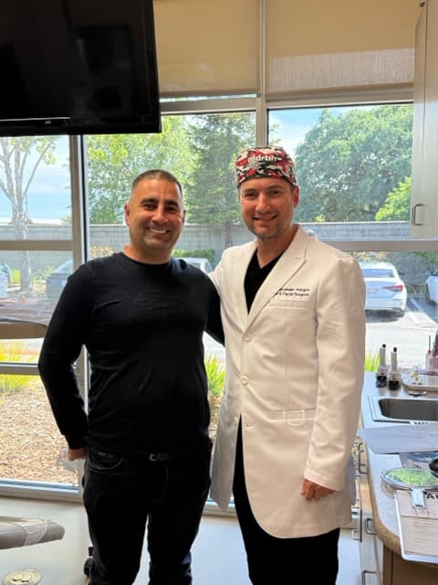 Dr. Alexander Antipov with a smiling dental implant patient at his Roseville, CA practice