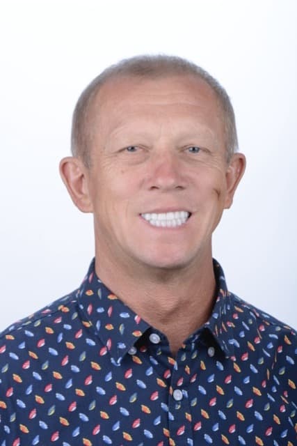 Male patient smiling after dental implant treatment