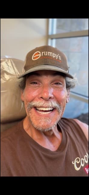 Male patient smiling after dental implant treatment
